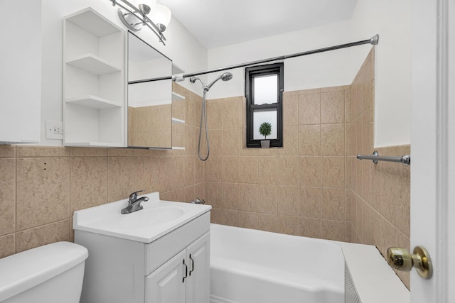 full bath featuring toilet, tile walls, shower / bathing tub combination, and vanity