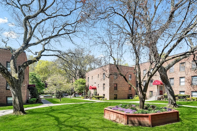 view of property's community with a lawn