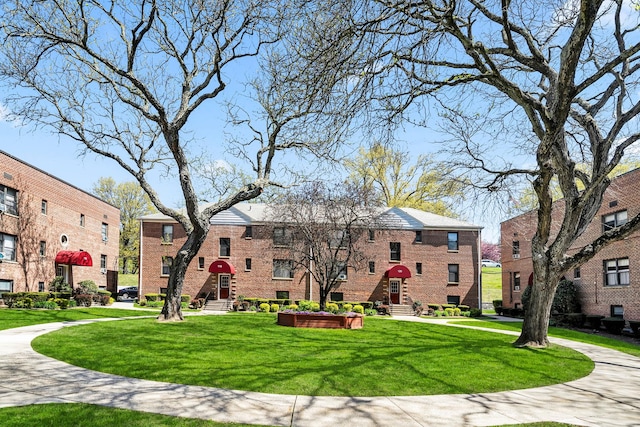 view of home's community featuring a yard and a residential view