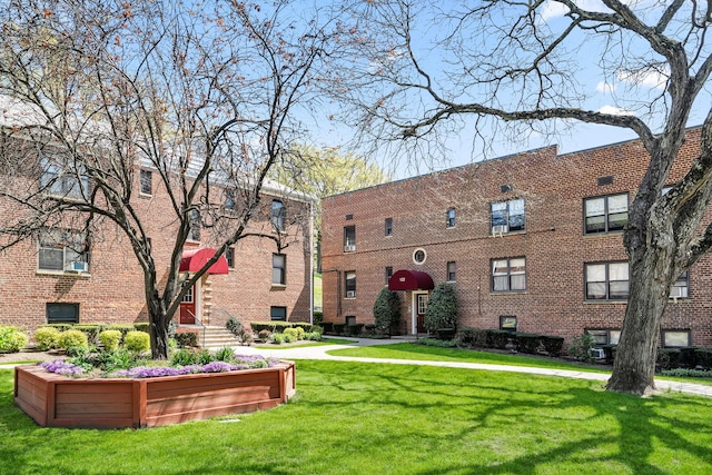 view of property's community with a lawn