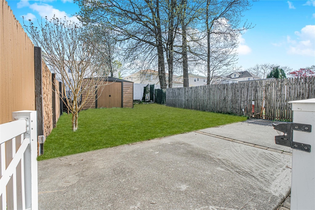 83 Vincent Ave, Staten Island, NY 10306 - view of yard with a fenced backyard, an outbuilding, a storage shed, and a patio