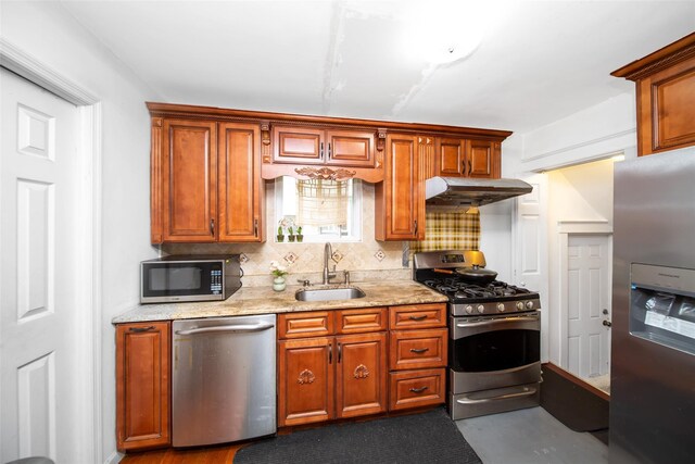6 Walnut Pl, Great Neck, NY 11021 - kitchen featuring stainless steel appliances, a sink, decorative backsplash, light stone countertops, and under cabinet range hood