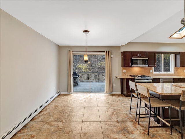 kitchen with dark brown cabinetry, decorative backsplash, a baseboard radiator, hanging light fixtures, and appliances with stainless steel finishes