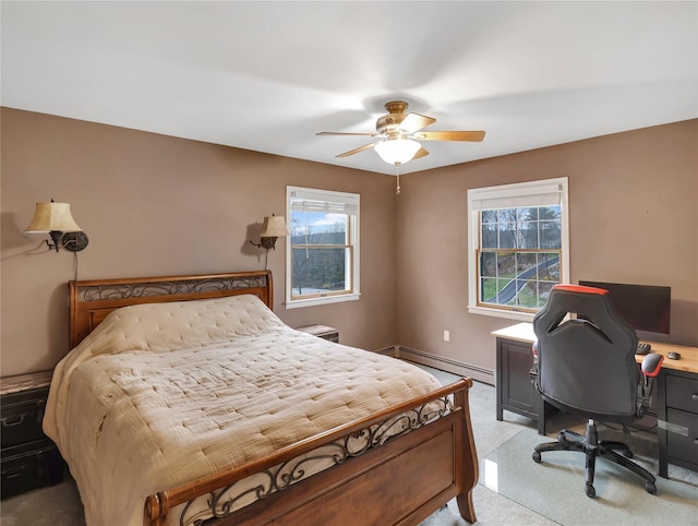 bedroom featuring a baseboard heating unit, ceiling fan, and light carpet