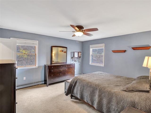 carpeted bedroom with a ceiling fan and baseboard heating