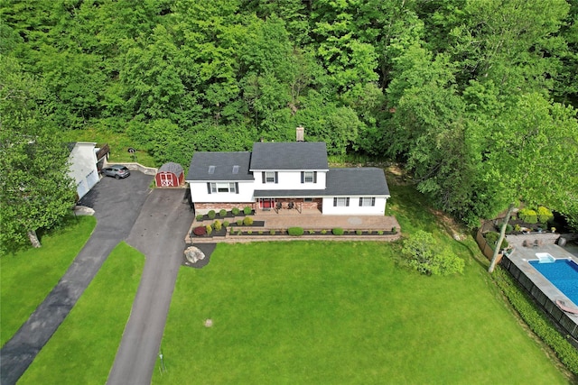 aerial view featuring a wooded view