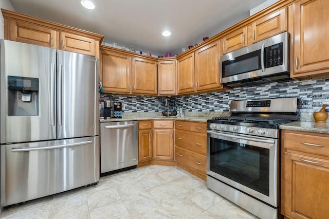 kitchen with decorative backsplash, brown cabinets, light stone counters, stainless steel appliances, and recessed lighting