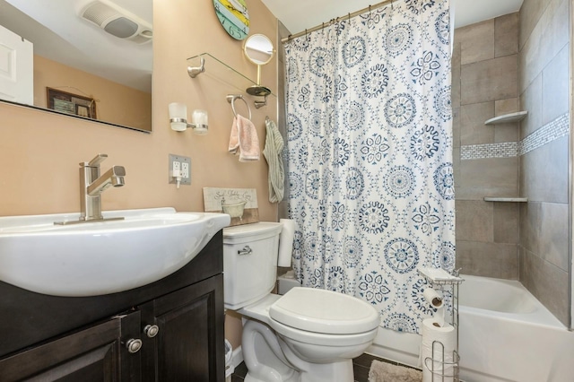 full bathroom with vanity, shower / bath combo with shower curtain, and toilet