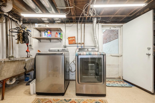 laundry area featuring laundry area, a sink, light floors, and washing machine and clothes dryer