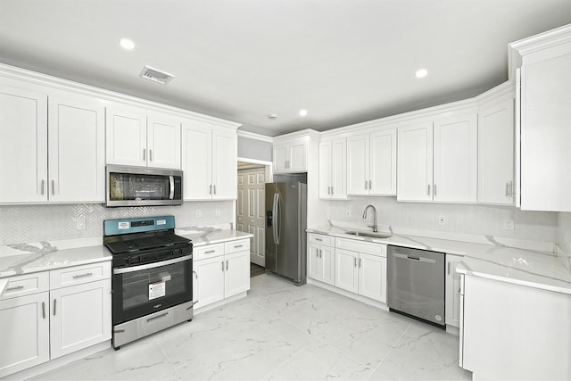 kitchen with white cabinets, marble finish floor, visible vents, a sink, and appliances with stainless steel finishes