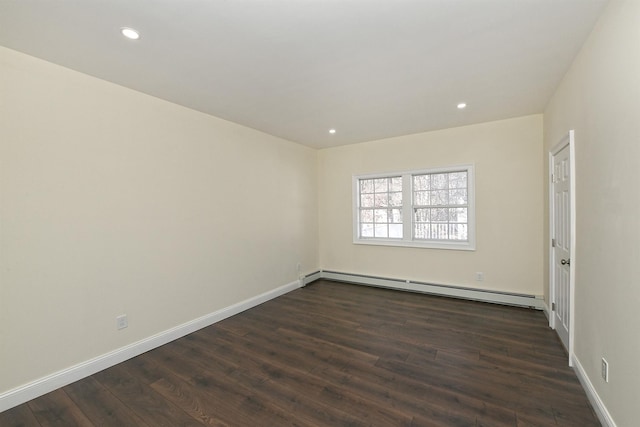 empty room with baseboard heating, baseboards, recessed lighting, and dark wood finished floors