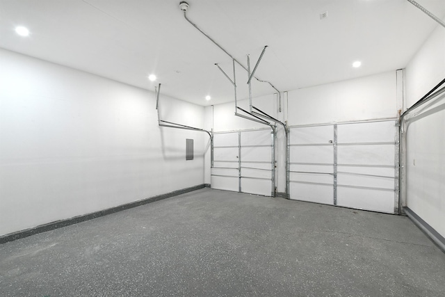 garage featuring baseboards and recessed lighting