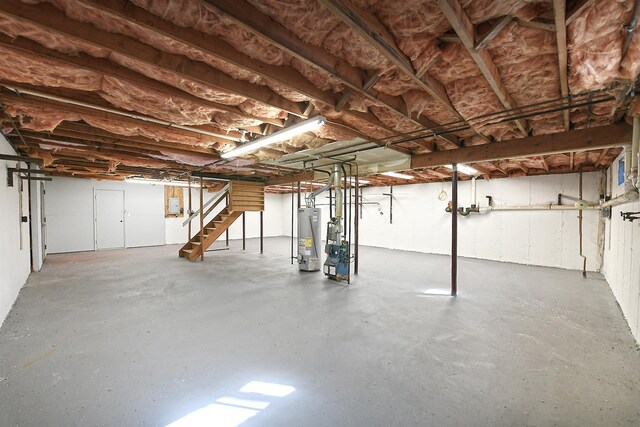 unfinished below grade area with stairway and water heater