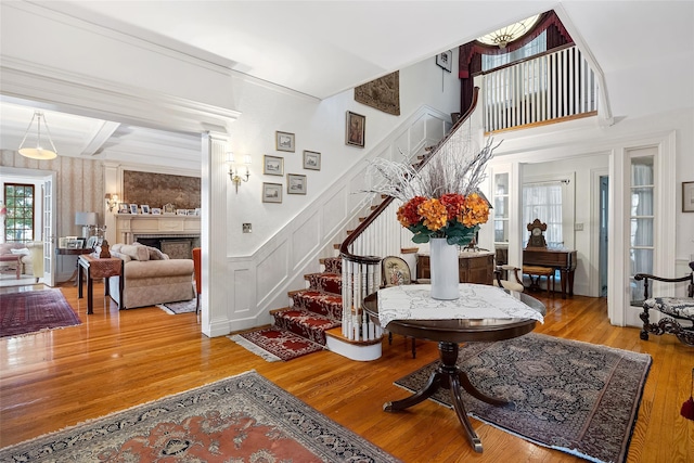 1271 Beverly Rd, Douglaston, NY 11363 - foyer with stairway, a decorative wall, wood finished floors, and a fireplace