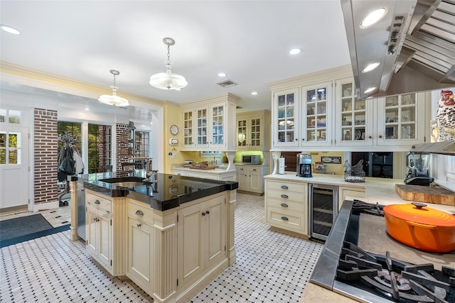1271 Beverly Rd, Douglaston, NY 11363 - kitchen featuring a sink, island range hood, cream cabinets, wine cooler, and visible vents