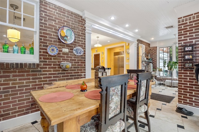 1271 Beverly Rd, Douglaston, NY 11363 - tiled dining area featuring recessed lighting, radiator heating unit, crown molding, and brick wall