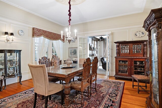 1271 Beverly Rd, Douglaston, NY 11363 - dining area featuring ornamental molding, light wood-style floors, and ceiling fan with notable chandelier
