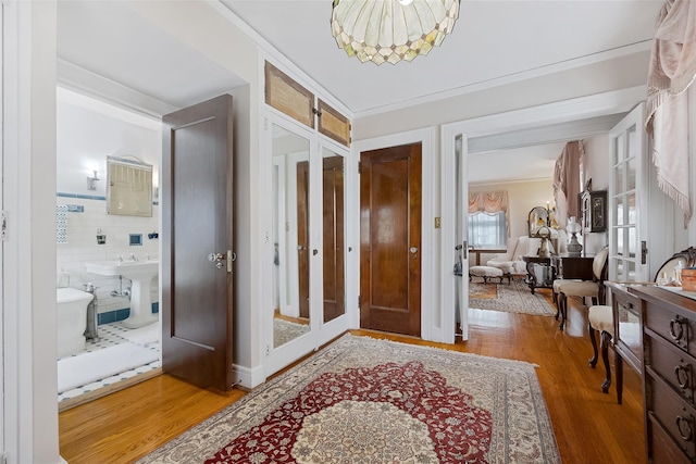 1271 Beverly Rd, Douglaston, NY 11363 - entrance foyer with french doors, wood finished floors, and ornamental molding