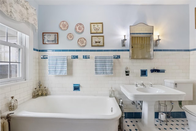 1271 Beverly Rd, Douglaston, NY 11363 - bathroom with tile walls, a garden tub, a wainscoted wall, and toilet