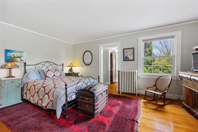 1271 Beverly Rd, Douglaston, NY 11363 - bedroom featuring radiator heating unit, crown molding, and light wood finished floors
