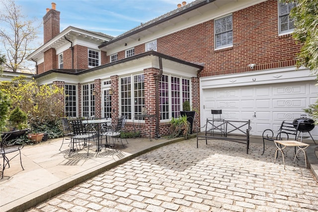1271 Beverly Rd, Douglaston, NY 11363 - view of patio featuring an attached garage