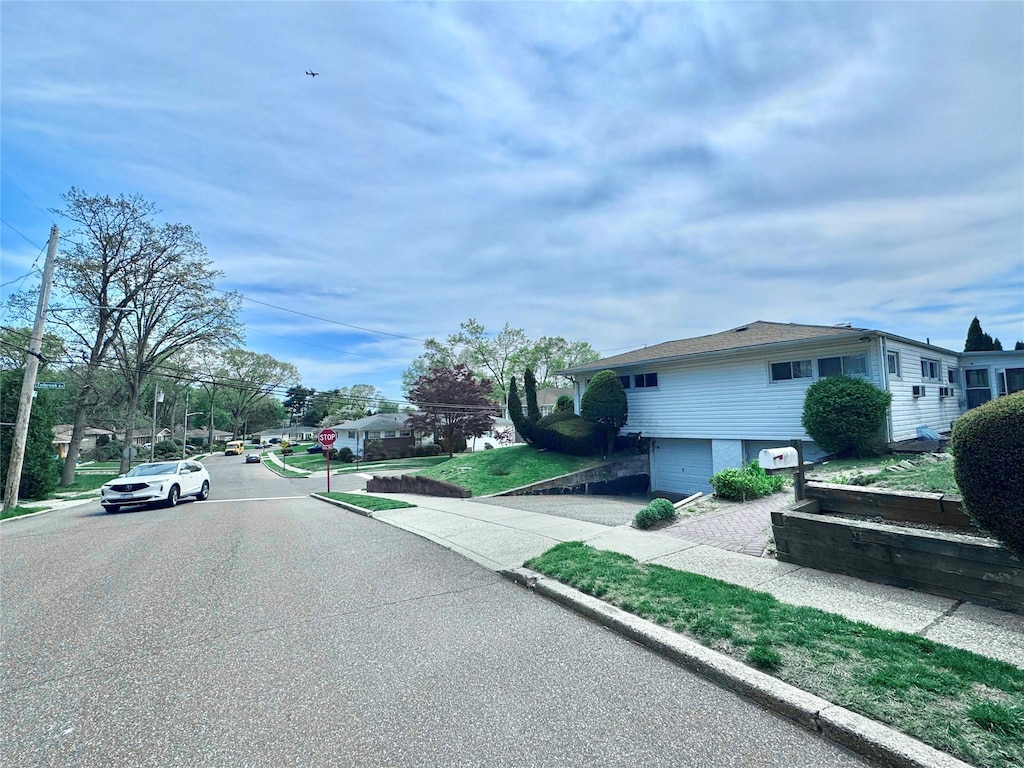 view of road with sidewalks, traffic signs, and curbs