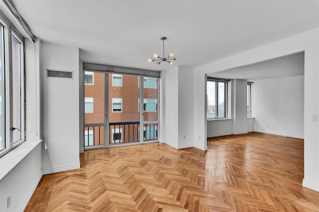 90 E End Ave Unit 10B, New York Manhattan, NY 10028 - empty room featuring a chandelier and baseboards