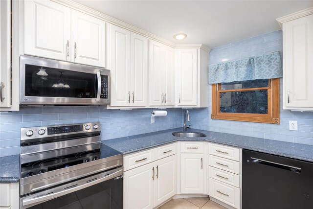 kitchen with tasteful backsplash, stainless steel appliances, white cabinetry, and a sink