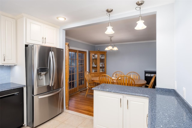 kitchen featuring crown molding, dark stone countertops, hanging light fixtures, stainless steel refrigerator with ice dispenser, and dishwashing machine