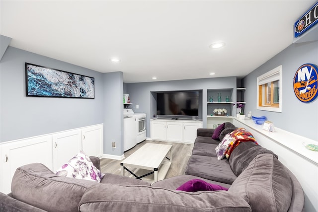 living area featuring washing machine and dryer, light wood finished floors, and recessed lighting