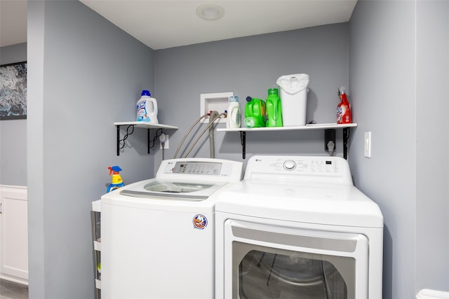 washroom with washing machine and clothes dryer