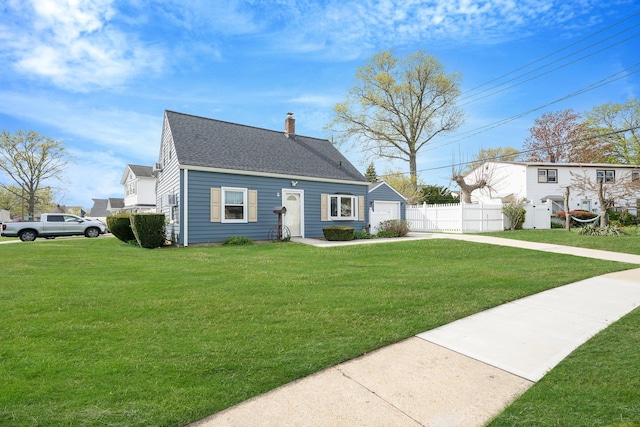 cape cod-style house featuring fence, roof with shingles, a garage, a front yard, and a chimney