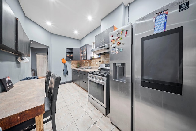 3219 104th St, East Elmhurst, NY 11369 - kitchen featuring light tile patterned floors, stainless steel appliances, under cabinet range hood, backsplash, and a sink