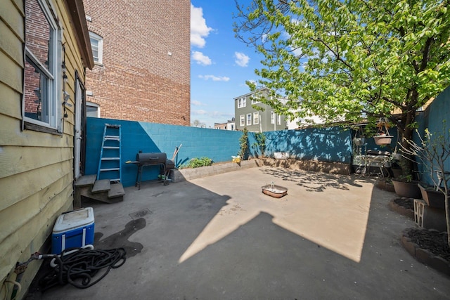 3219 104th St, East Elmhurst, NY 11369 - view of patio with a fenced backyard and a grill