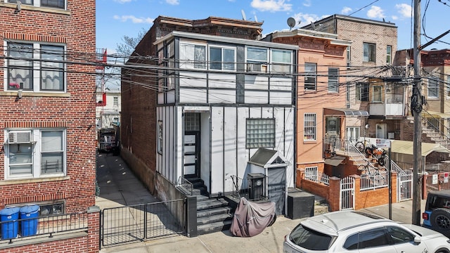 3219 104th St, East Elmhurst, NY 11369 - view of front of home with fence, entry steps, and brick siding