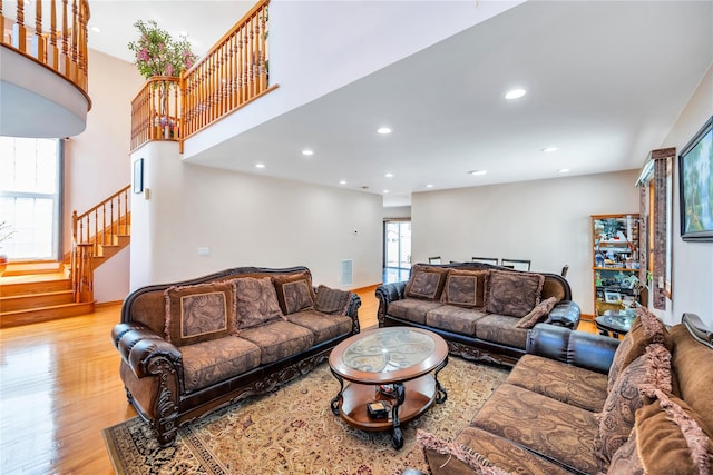 living area with stairway, recessed lighting, visible vents, and light wood-style flooring