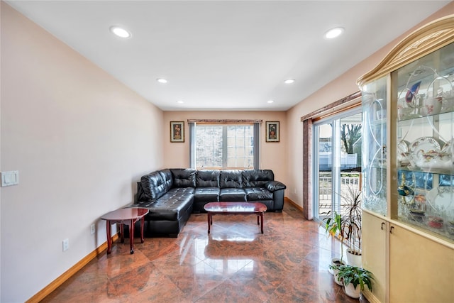 living room featuring baseboards and recessed lighting