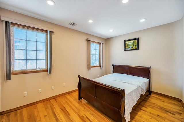bedroom featuring baseboards, visible vents, light wood finished floors, and recessed lighting