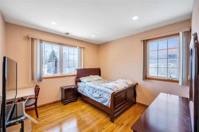 bedroom featuring light wood-style flooring, baseboards, recessed lighting, and multiple windows