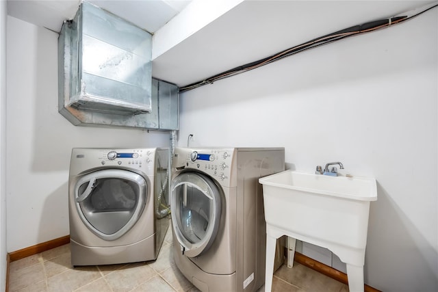 washroom featuring a sink, independent washer and dryer, laundry area, and light tile patterned floors