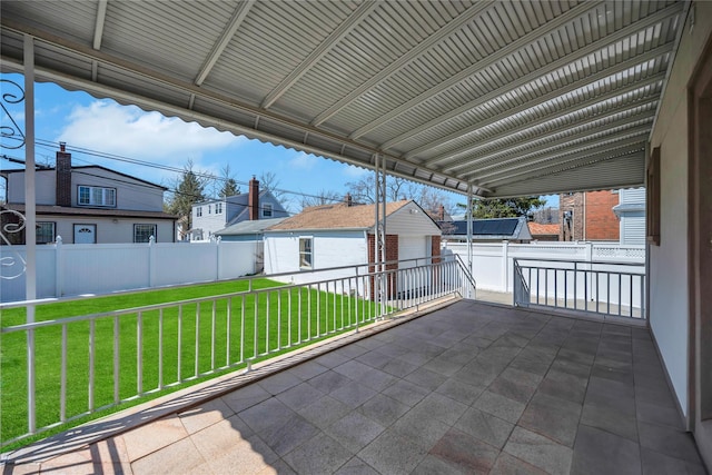 view of patio featuring a residential view, an outbuilding, and a fenced backyard