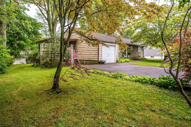 24 Briarbrook Rd, Ossining, NY 10562 - view of front of house featuring an attached garage, asphalt driveway, and a front lawn