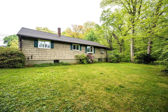 24 Briarbrook Rd, Ossining, NY 10562 - rear view of property with a chimney, a yard, and roof with shingles