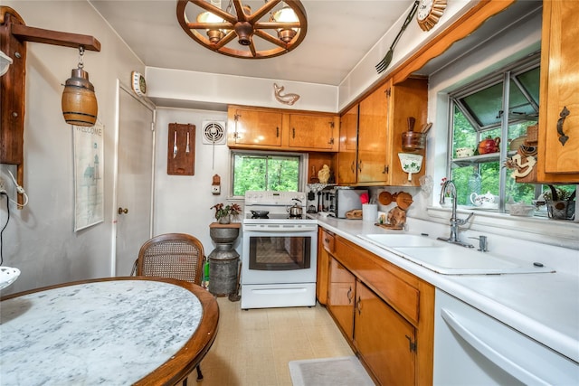 24 Briarbrook Rd, Ossining, NY 10562 - kitchen with white appliances, a sink, light countertops, brown cabinetry, and a chandelier