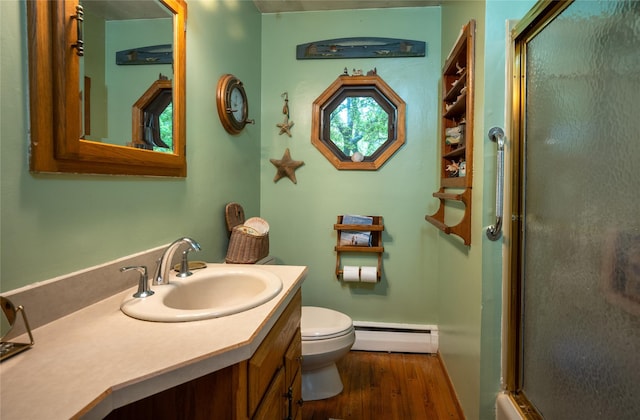 24 Briarbrook Rd, Ossining, NY 10562 - bathroom featuring a baseboard heating unit, a shower with shower door, wood finished floors, toilet, and vanity
