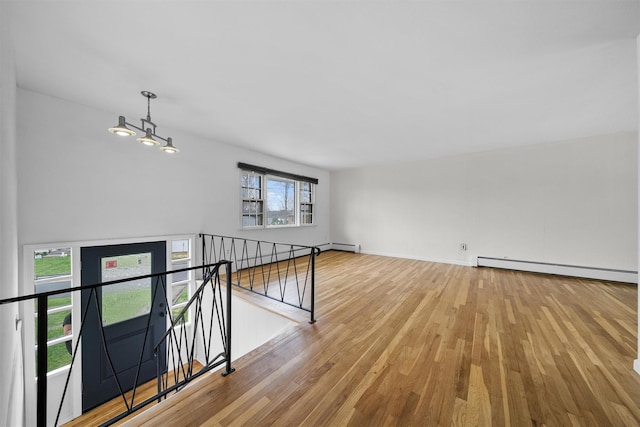 125 Lakewood Dr, Congers, NY 10920 - spare room with baseboard heating and wood finished floors
