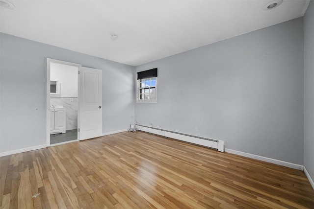 125 Lakewood Dr, Congers, NY 10920 - unfurnished bedroom featuring baseboard heating, light wood-style flooring, and ensuite bathroom