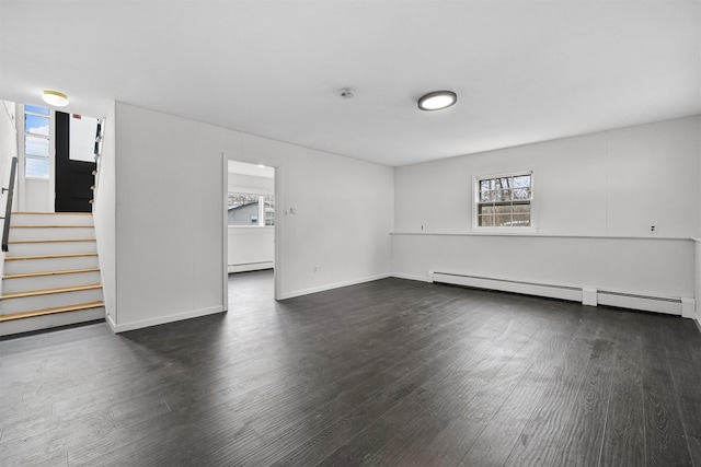 125 Lakewood Dr, Congers, NY 10920 - spare room featuring baseboard heating, dark wood-type flooring, and stairs
