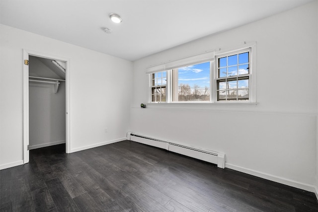 125 Lakewood Dr, Congers, NY 10920 - unfurnished bedroom featuring a baseboard heating unit, dark wood-style floors, and a closet