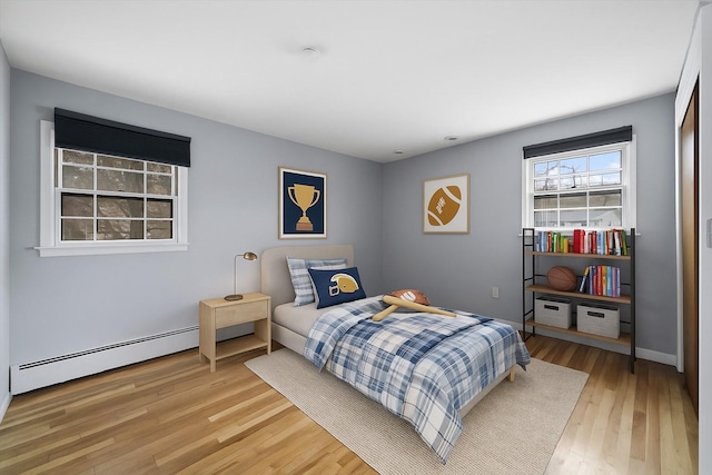 125 Lakewood Dr, Congers, NY 10920 - bedroom with a baseboard heating unit and light wood-type flooring